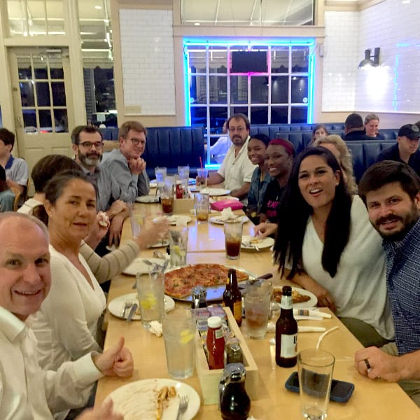 Friends and family sharing pizza at Pepperoni Cafe