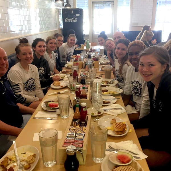A team gathered around a long table for a meal